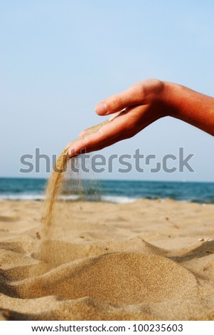 sand running through hands as a symbol for time running, lost etc.............