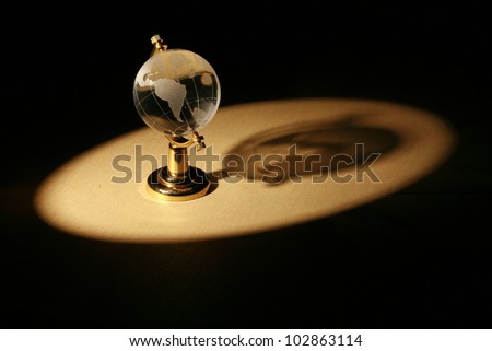 a glass globe in dramatic lighting............