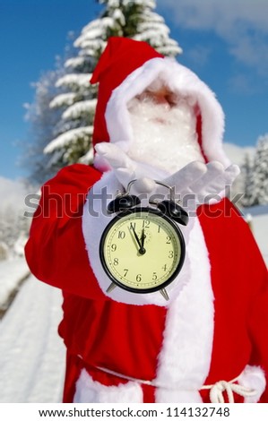 Santa Claus, Father Christmas holds watch clock