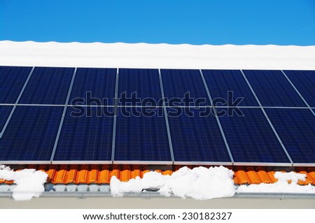 solarcells on a winter roof with snow...