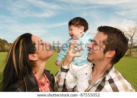 A young happy family with their 4  month old son