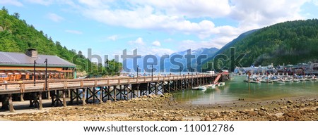 Panoramic view on Vancouver Island wooden mooring against summer mountain forest landscape. (Vancouver Island,British Columbia,Canada)