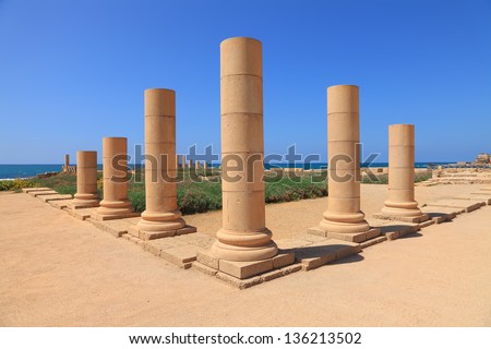 Marble column triangle with blue sky and sea in background. Mediterranean, Caesarea antique town reserve, Israel