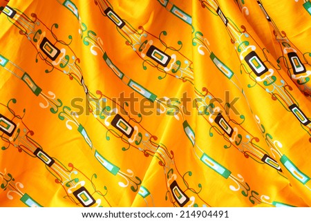 Yellow geometrical pattern drapery (creased) fabric background or texture