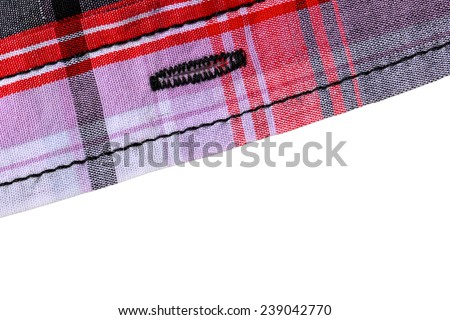 Cloth fragment sample of a red -white -black cotton plaid shirt on white background