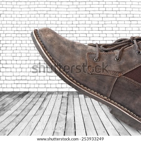 Boot steps on the grunge style wood and wall texture background
