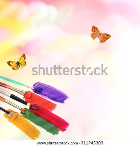 Natural motion blur colors background with butterflies and art brushes with acrylic paints. Nature and natural colors art abstract background with copy space
