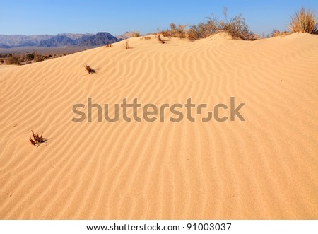 Sand dunes in Arava desert on the background of mountains and blue sky ...