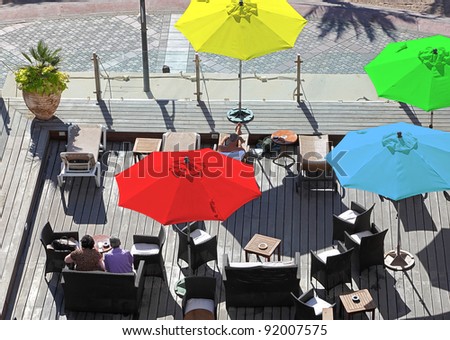 Top view on the open area of seaside cafe with color umbrellas