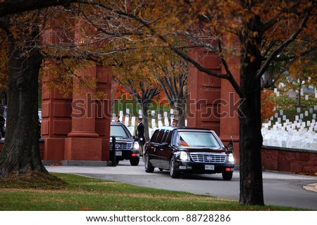 ARLINGTON, VA - NOVEMBER 11: The Presidential motorcade exits Arlington National Cemetery through McClellan Gate after Veterans Day Ceremonies on November 11, 2011 in Arlington, VA