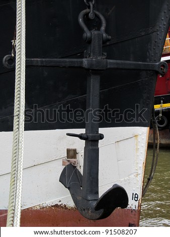Anchor hanging off the side of a ship