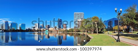 Orlando Lake Eola in the morning with urban skyscrapers and clear blue sky.