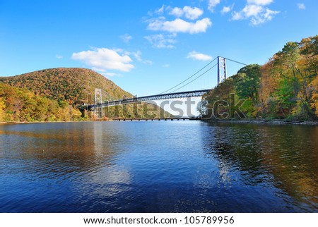 Bear Mountain with Hudson River and bridge in Autumn with colorful foliage and water reflection.