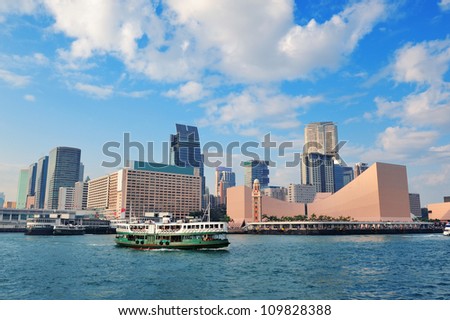 Urban architecture in Hong Kong Victoria Harbor in the day with blue sky, boat and cloud.