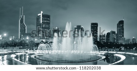 Shanghai People\'s Square with fountain and urban skyline at night panorama in black and white