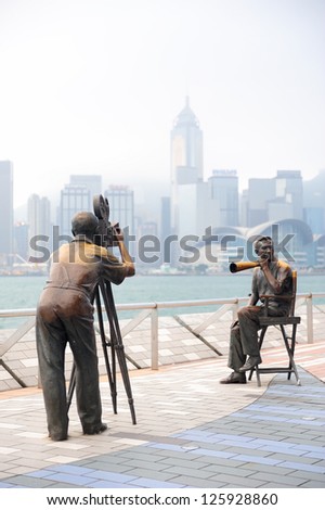 HONG KONG, CHINA - APR 17: Statue and skyline in Avenue of Stars on April 17, 2012 in Hong Kong, China. The promenade honours celebrities of the Hong Kong film industry as the famous city attraction.