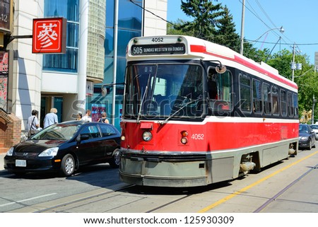 TORONTO, CANADA - JULY 2: Light rail in Chinatown  on July 2, 2012 in Toronto. It is one of the largest Chinatowns in North America and Chinese-Canadian Communities in Great Toronto Area.