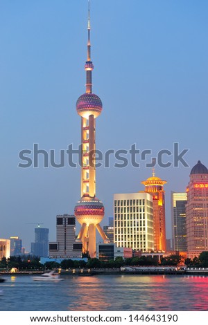 SHANGHAI, CHINA - JUNE 2: Oriental Pearl Tower over river on JUNE 2, 2012 in Shanghai, China. The tower was the tallest structure in China excluding Taiwan from 1994~2007 and the landmark of Shanghai.