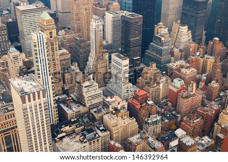 New York City Manhattan skyline aerial view with street and skyscrapers at sunset.