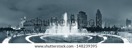 Shanghai People's Square with fountain and urban skyline at night panorama in black and white