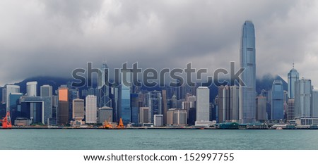 Urban architecture in Hong Kong Victoria Harbor with city skyline and cloud in the day.