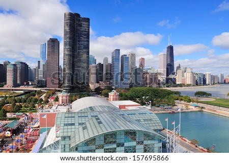Chicago city downtown urban skyline with skyscrapers over Lake Michigan with cloudy blue sky.
