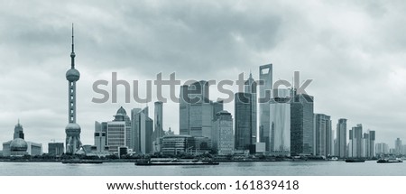 Shanghai skyline over river in overcast day in black and white