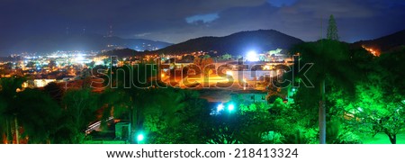 Vacation resort over mountain at night with lights in San Juan, Puerto Rico.