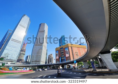 Shanghai street view with skyscrapers and blue sky.