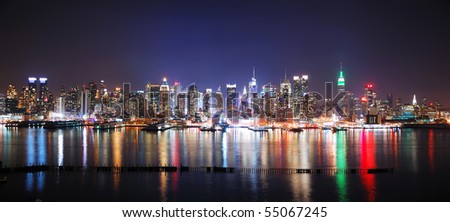 New York City Manhattan Times Square night panorama with Empire State Building and reflection over Hudson River.