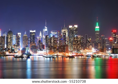 New York City Skyline with Times Square and Empire State Building at night.