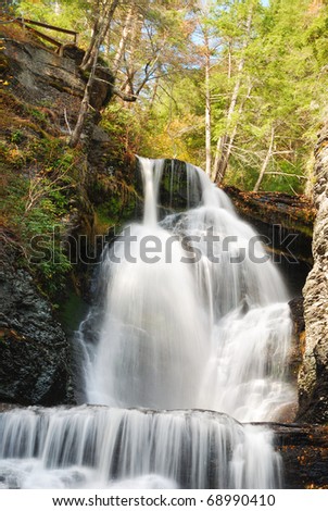 Waterfall in Autumn mountain with woods, foliage and rocks. From Digmans Fall of Pennsylvania