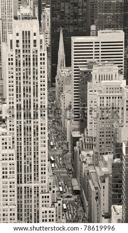 Urban city street aerial view in black and white. New York City Manhattan with skyscrapers, pedestrian and busy traffic.