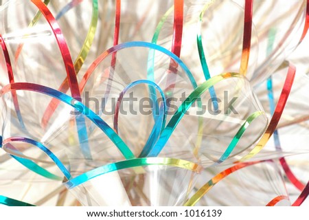 Closeup of transparent rainbow ribbon on white background