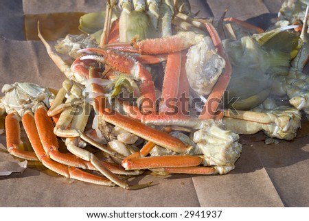 A seafood medley of steaming crab legs, crayfish and vegetables