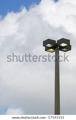 Quad head street light on during the day