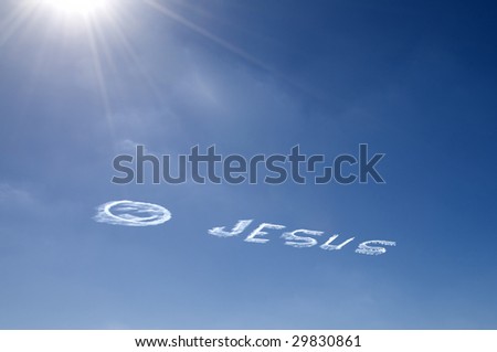 Sky writing Jesus with a happy face on blue sky and sun bursting rays