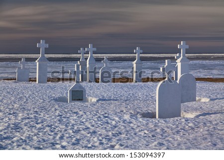 White tomb stones in a winter cemetery.