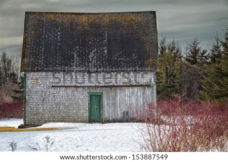 An old barn in the winter landscape.