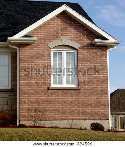 Window of newly constructed brick home.