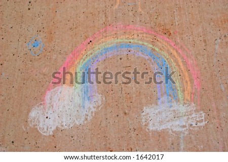 A child's drawing on the sidewalk of a rainbow.