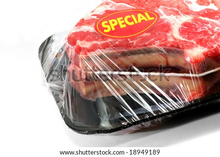 A prime rib roast packaged and wrapped in cellophane.