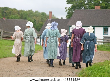 Re-enactment of a pioneer village with a group in period costume.