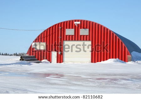 Potato storage warehouse facility surrounded by ice and snow on Prince Edward Island, Canada.