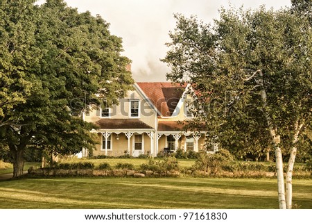 A north American style old farm house in the country. Victorian architecture.