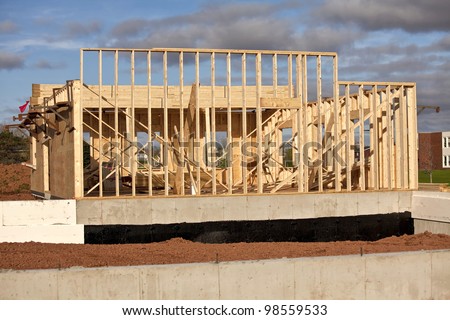 Construction of a wood frame home or building with an insulated cement foundation.