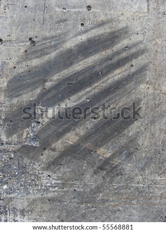 worn dirty concrete wall with rubber tire mark
