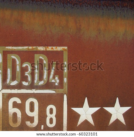 fonts numbers and stars on rusty piece of metal from a train