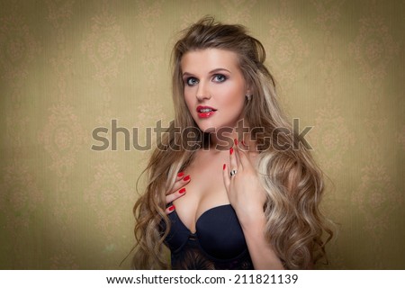 Portrait of young beautiful girl with long hair near the wall in the corner