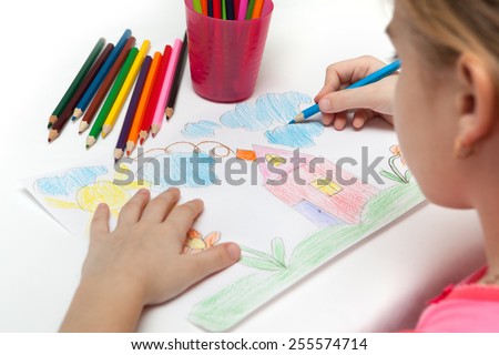 Child draws a pencil drawing of the world